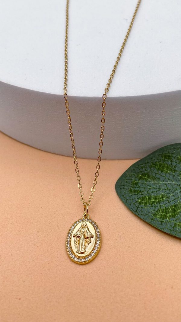 Collier Vierge Marie en plaqué or avec médaille ovale sertie de zirconiums, posé à plat